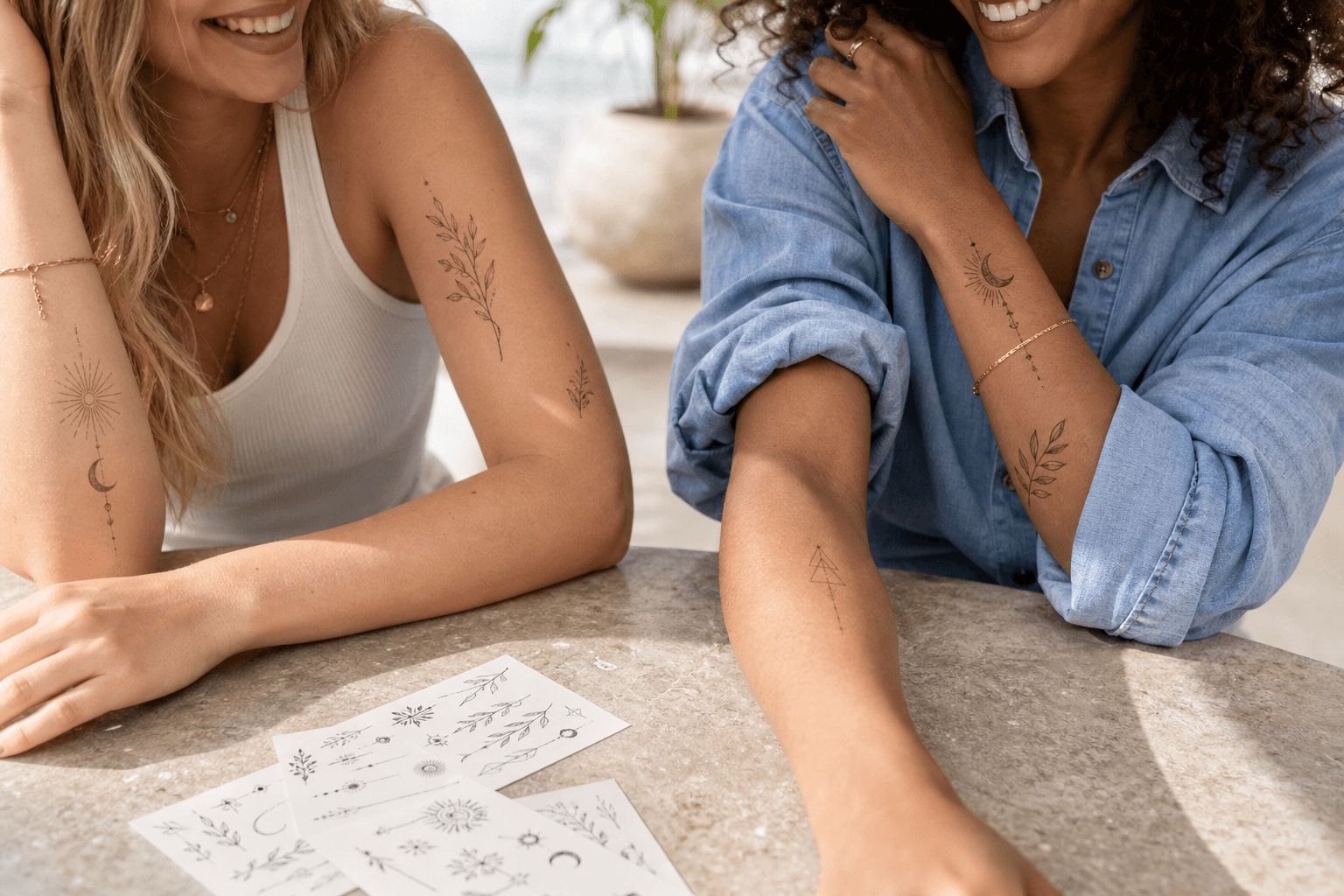 Diverse adults wearing modern botanical, celestial and geometric temporary tattoos